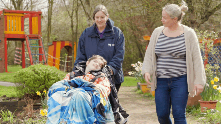 Boy with mum and hospice nurse