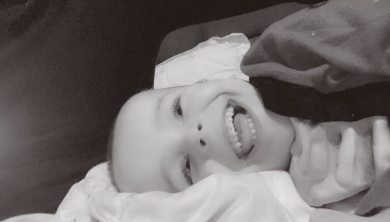 A boy is smiling at the camera